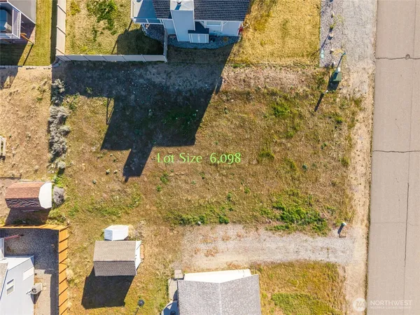 a view of a house with a yard and mountain view in back