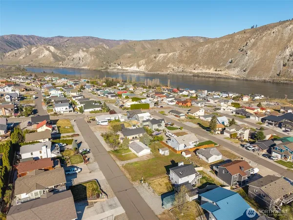an aerial view of residential houses with outdoor space and river