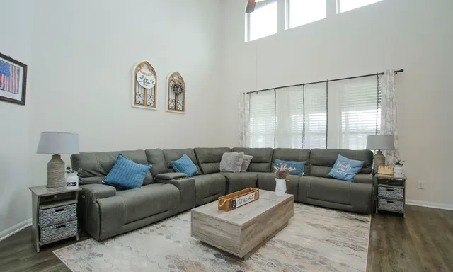 a living room with furniture wooden floor and a view of kitchen