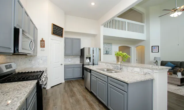 a living room with furniture and stairs