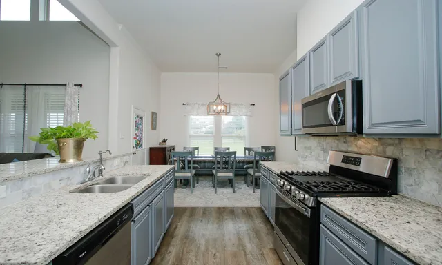 a kitchen with a sink stove and refrigerator