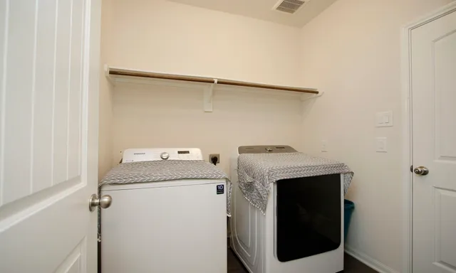 a kitchen with granite countertop lots of wooden furniture
