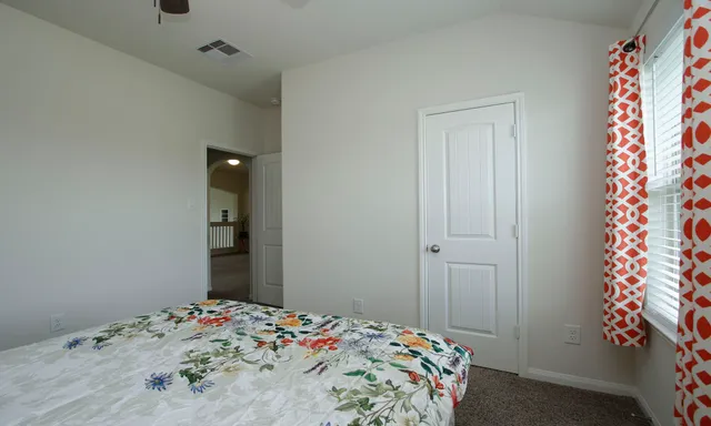 a bedroom with bed and a chandelier
