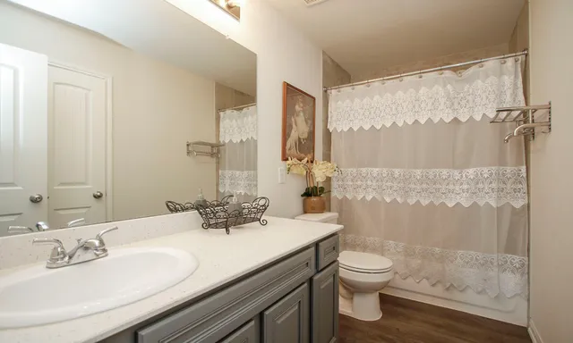 a bedroom with a bed and a ceiling fan