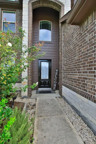 a view of a house with a yard and tree s