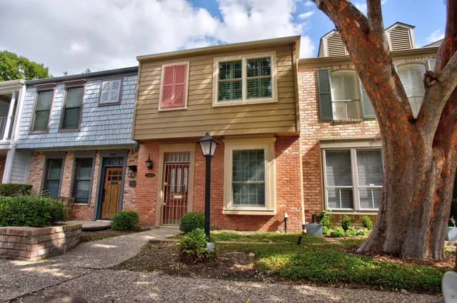 a front view of a house with garden and porch