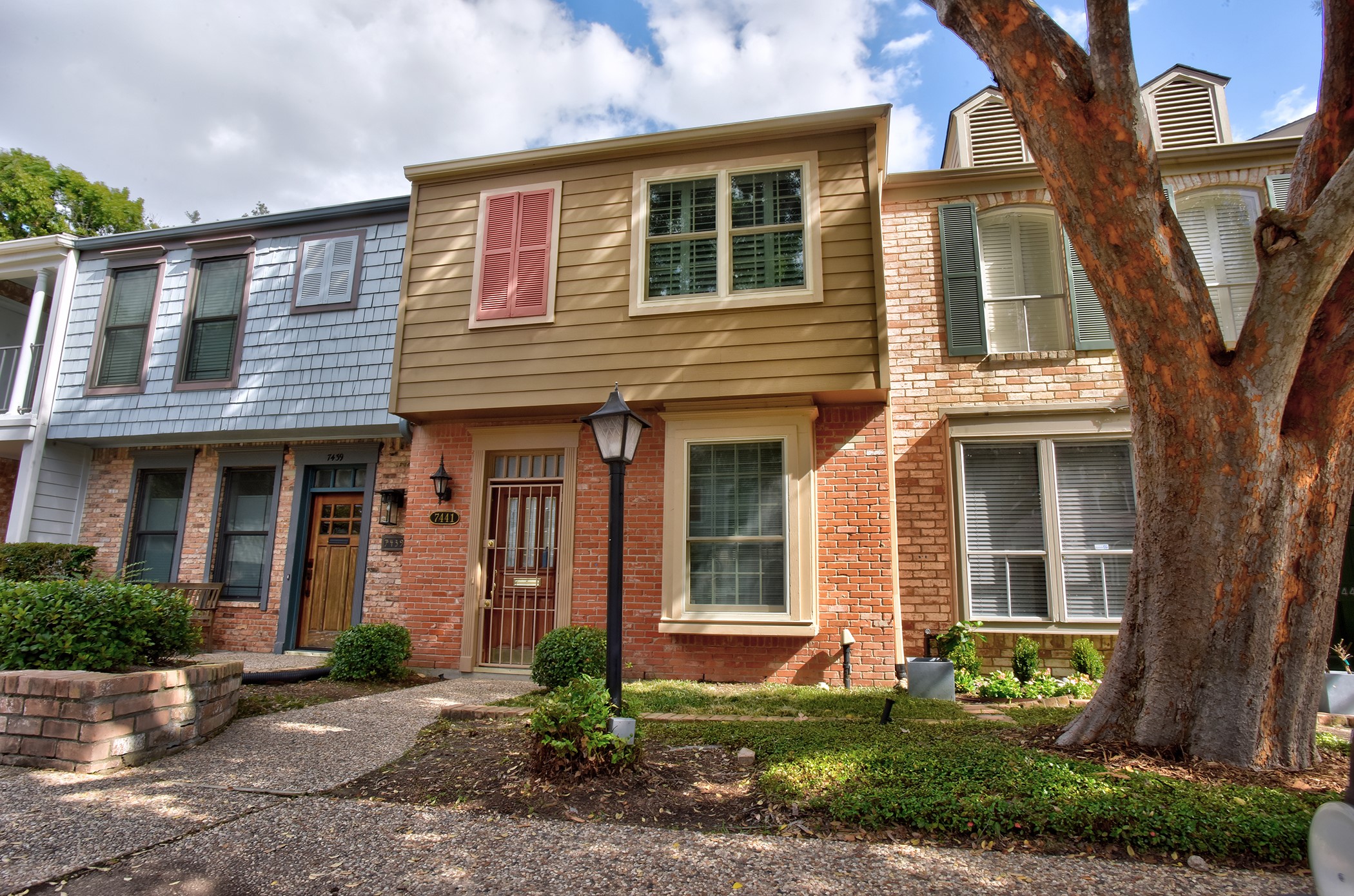 a front view of a house with garden and porch