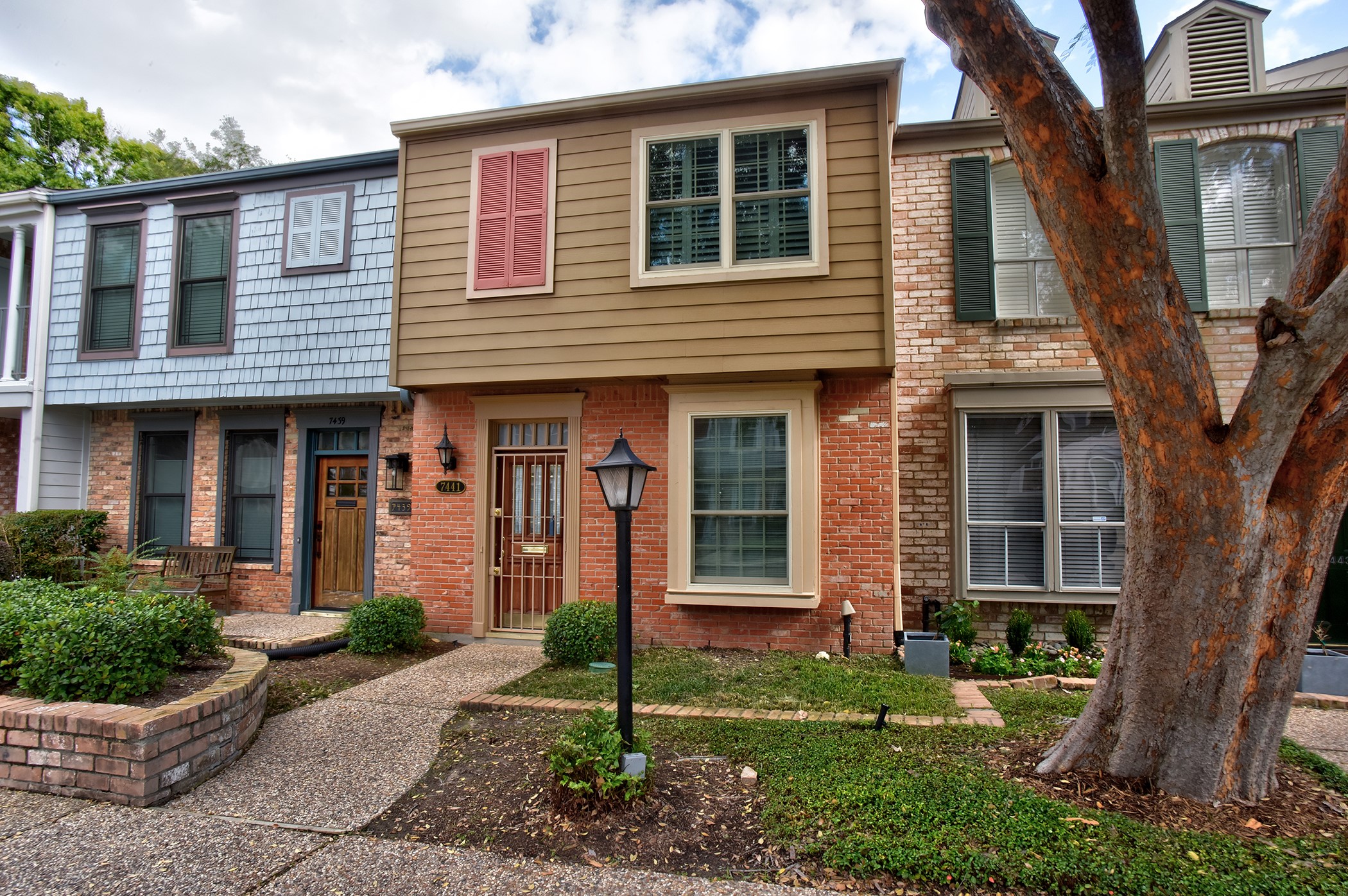 7441 Brompton Street Houston, TX 77025 - Photo 2 of 21 a front view of a house with garden