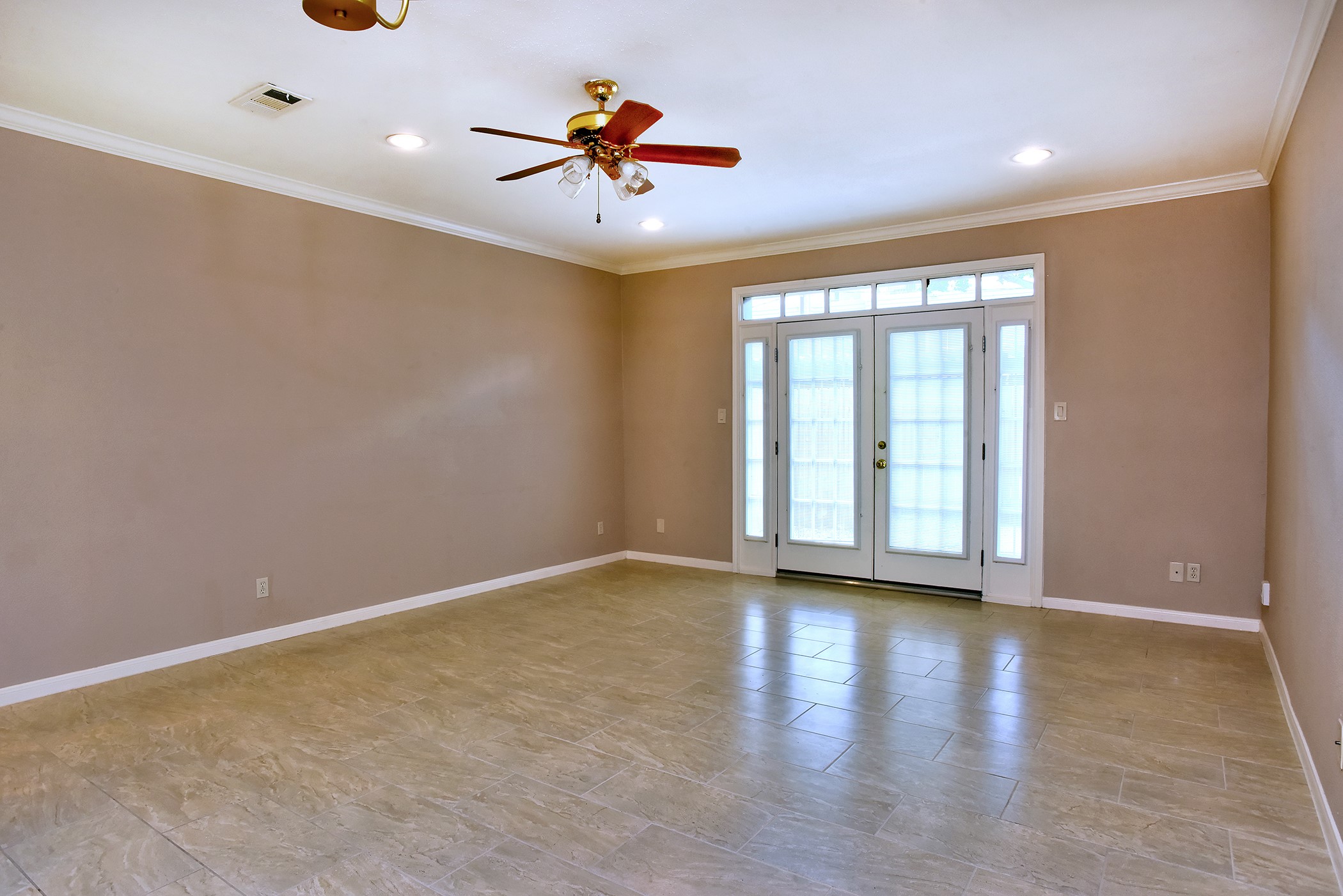 7441 Brompton Street Houston, TX 77025 - Photo 6 of 21 a view of an empty room with window and wooden floor