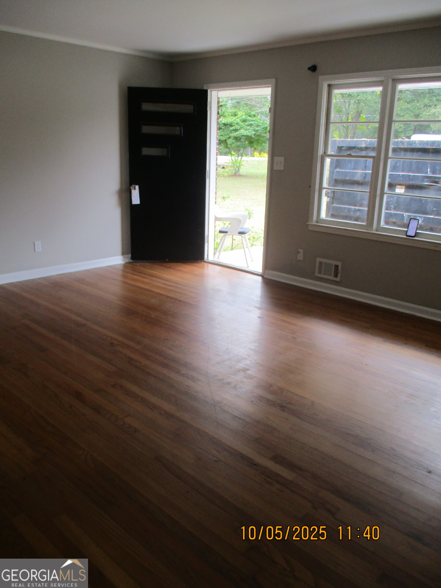 9182 Flat Shoals Road Southwest, Unit STREET Covington, GA 30014 - Photo 11 of 13 a view of an empty room with wooden floor and a window