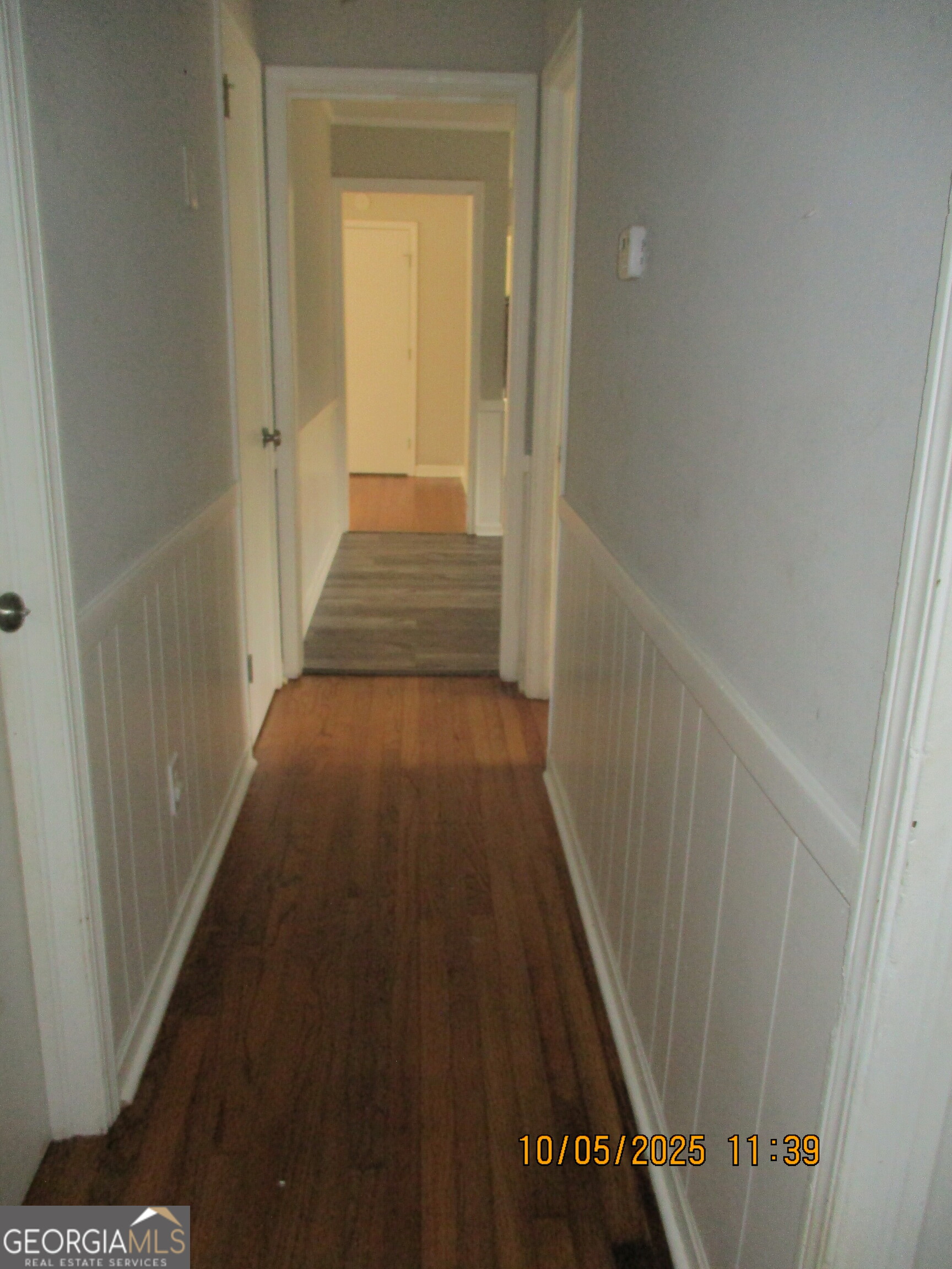 9182 Flat Shoals Road Southwest, Unit STREET Covington, GA 30014 - Photo 10 of 13 a view of a hallway with wooden floor and staircase