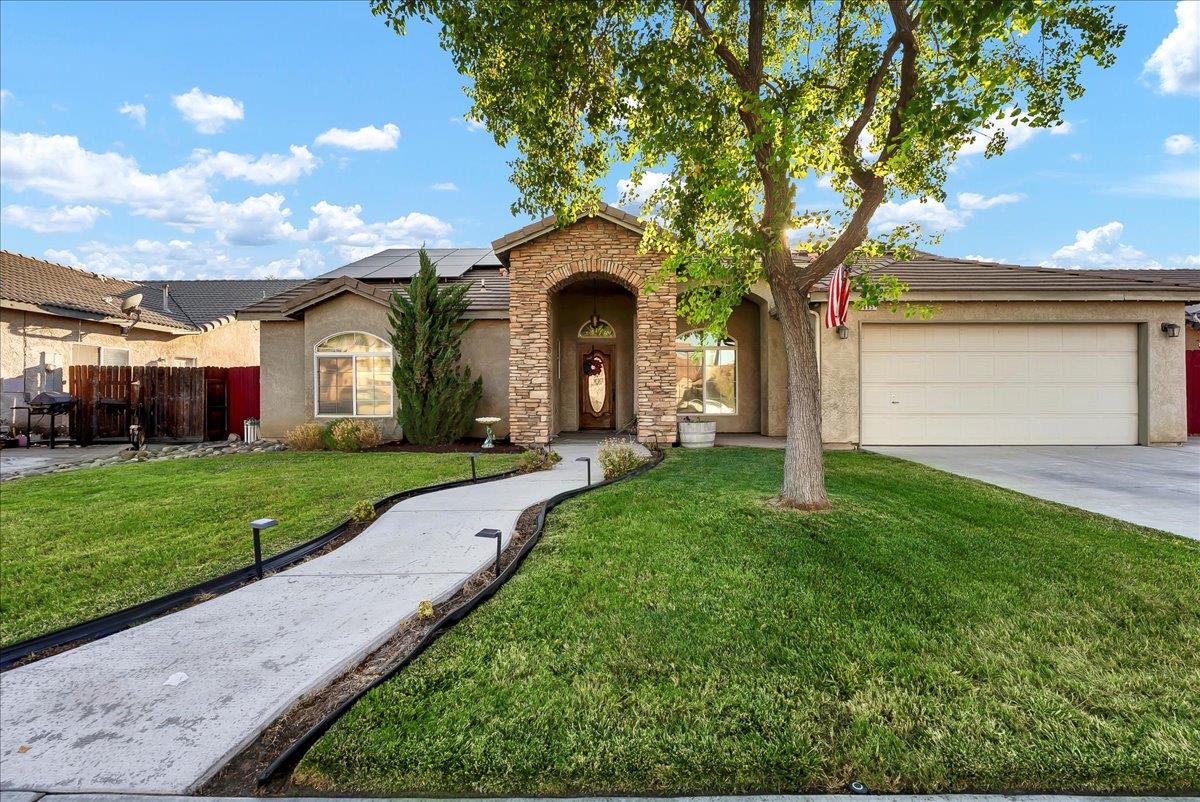 a front view of a house with garden