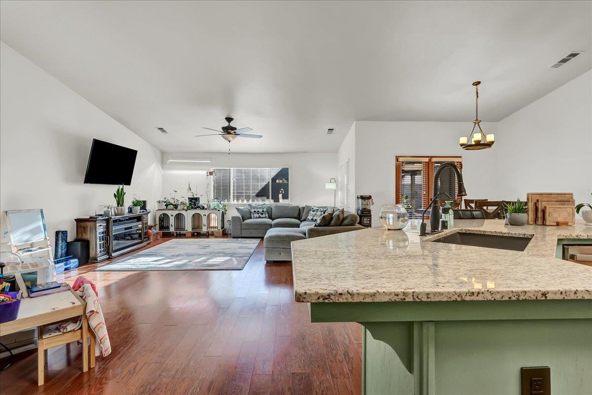 695 Crescent Lane Lemoore, CA 93245 - Photo 16 of 51 a kitchen with sink stove and wooden floor