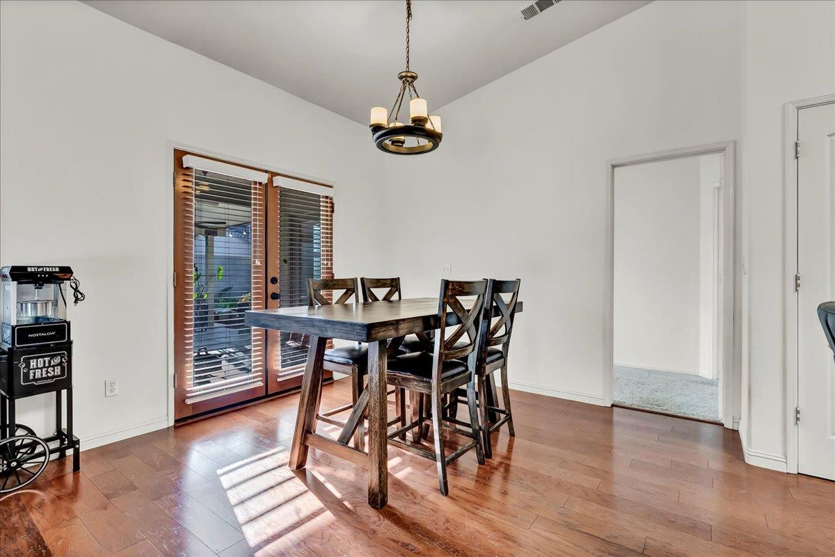 695 Crescent Lane Lemoore, CA 93245 - Photo 20 of 51 a view of a dining room with furniture and wooden floor