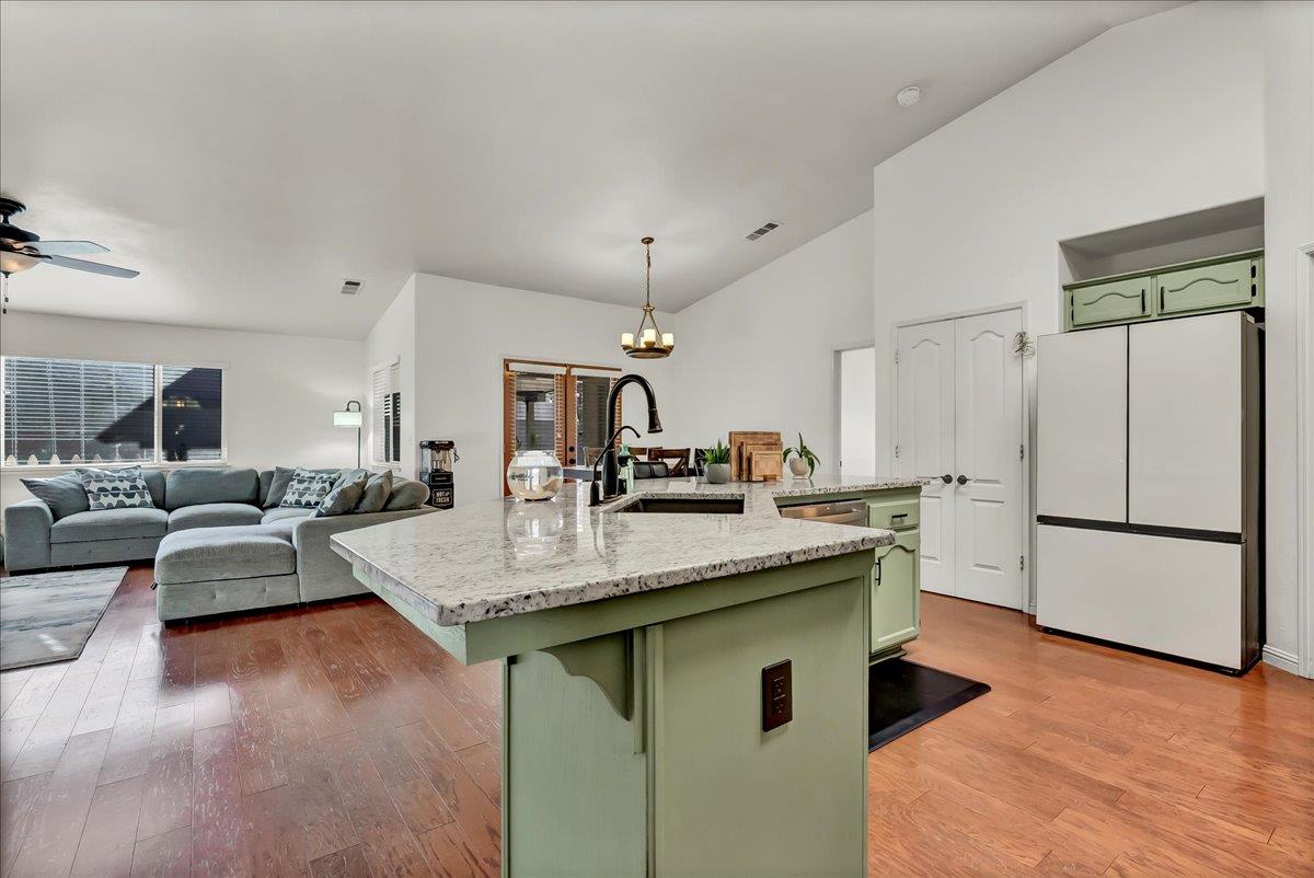 695 Crescent Lane Lemoore, CA 93245 - Photo 24 of 51 a kitchen with stainless steel appliances granite countertop a sink stove and refrigerator