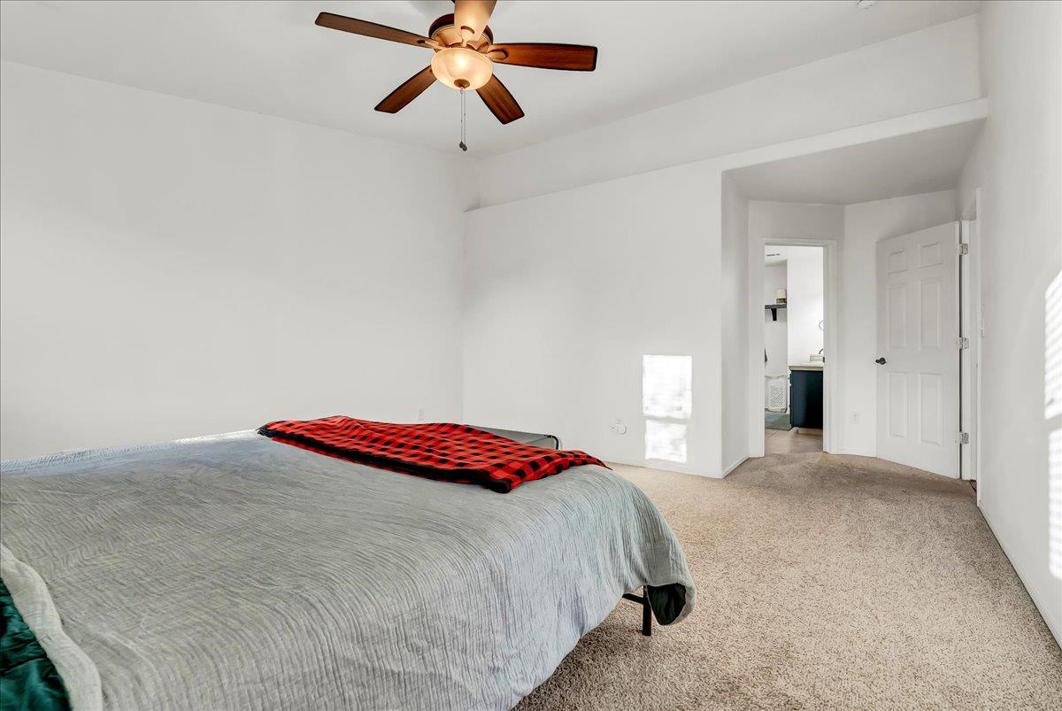 695 Crescent Lane Lemoore, CA 93245 - Photo 37 of 51 a bedroom with a bed and a chandelier
