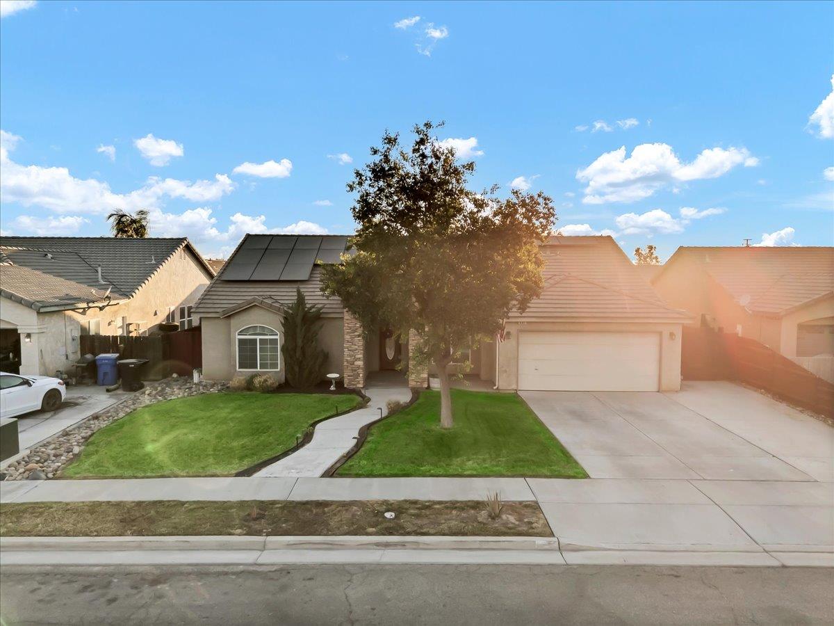 695 Crescent Lane Lemoore, CA 93245 - Photo 4 of 51 a front view of a house with a yard and garage