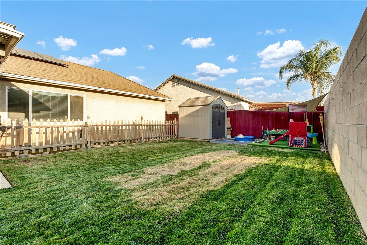 695 Crescent Lane Lemoore, CA 93245 - Photo 45 of 51 a view of a backyard with table and chairs and potted plants