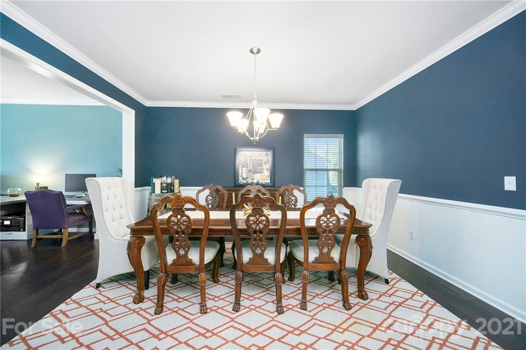 2159 Stone Pile Drive Concord, NC 28025 - Photo 13 of 33 a view of a dining room with furniture and wooden floor