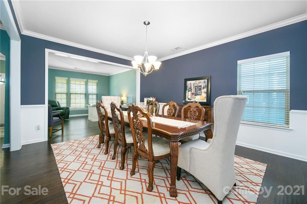 2159 Stone Pile Drive Concord, NC 28025 - Photo 14 of 33 a view of a dining room with furniture and wooden floor