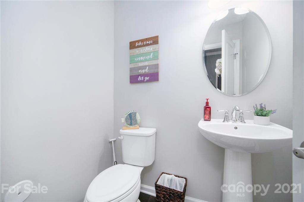 2159 Stone Pile Drive Concord, NC 28025 - Photo 18 of 33 a bathroom with a toilet a sink and a mirror