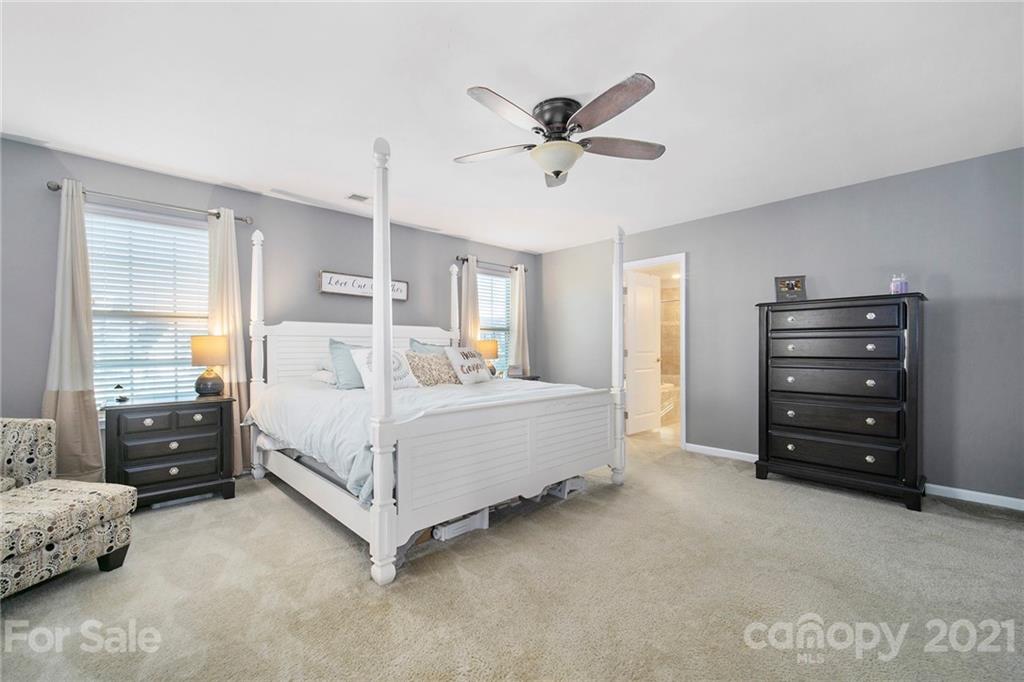 2159 Stone Pile Drive Concord, NC 28025 - Photo 19 of 33 a bedroom with a bed and a chandelier