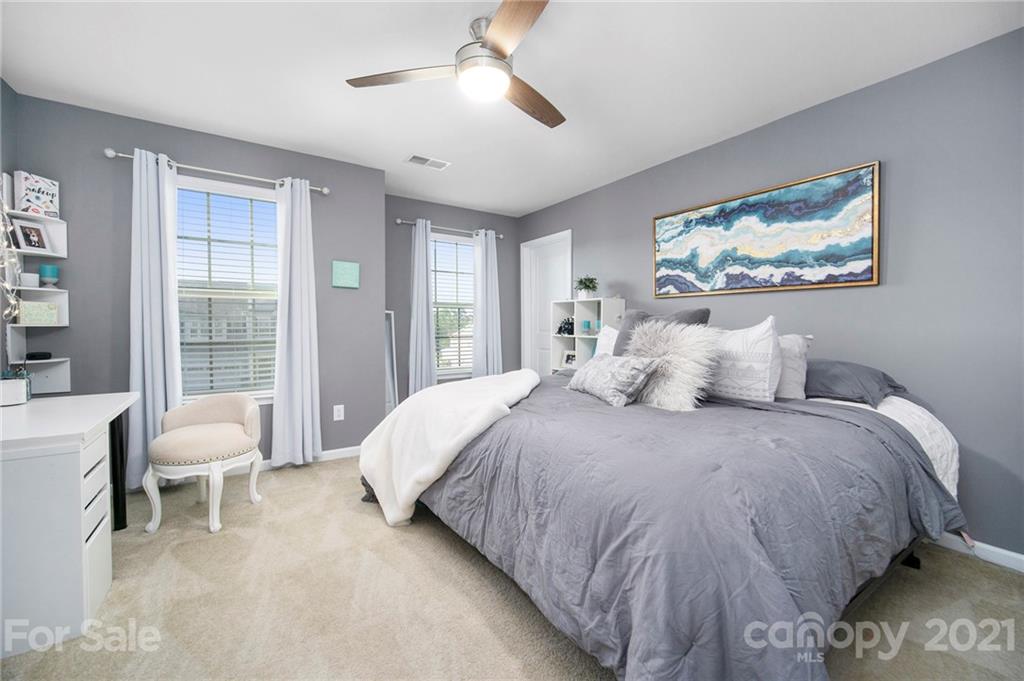 2159 Stone Pile Drive Concord, NC 28025 - Photo 28 of 33 a bedroom with a bed and a chandelier