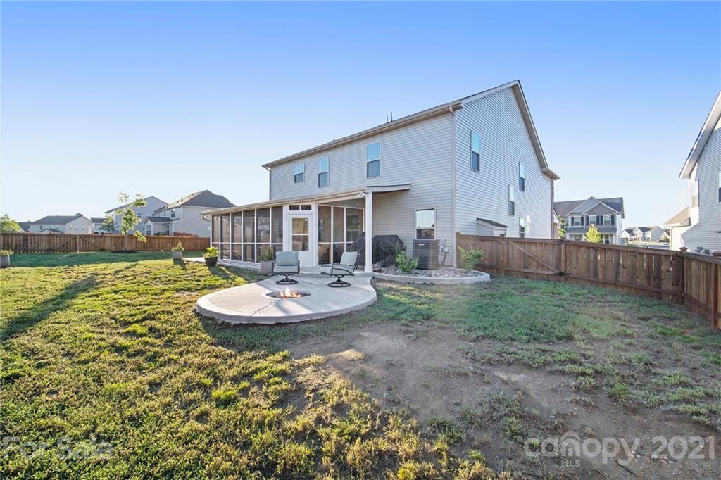 2159 Stone Pile Drive Concord, NC 28025 - Photo 33 of 33 a backyard of a house with table and chairs