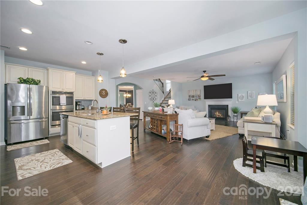 2159 Stone Pile Drive Concord, NC 28025 - Photo 7 of 33 a living room with furniture and kitchen view