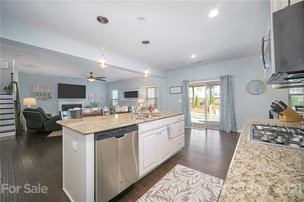 2159 Stone Pile Drive Concord, NC 28025 - Photo 8 of 33 a large kitchen with stainless steel appliances kitchen island granite countertop a sink and cabinets