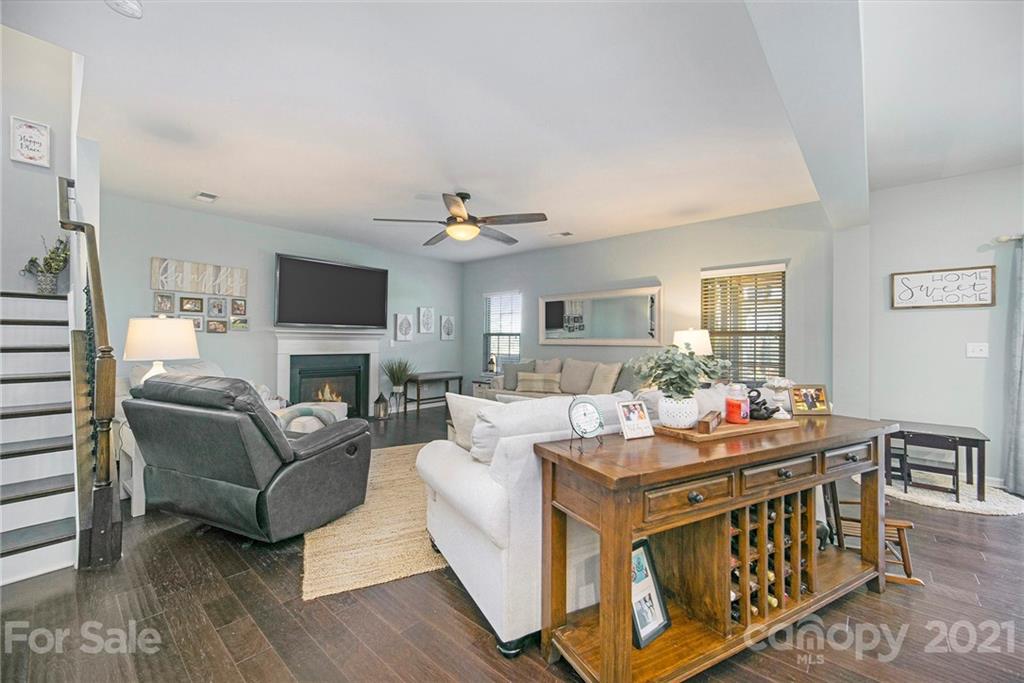 2159 Stone Pile Drive Concord, NC 28025 - Photo 10 of 33 a living room with fireplace furniture and a wooden floor