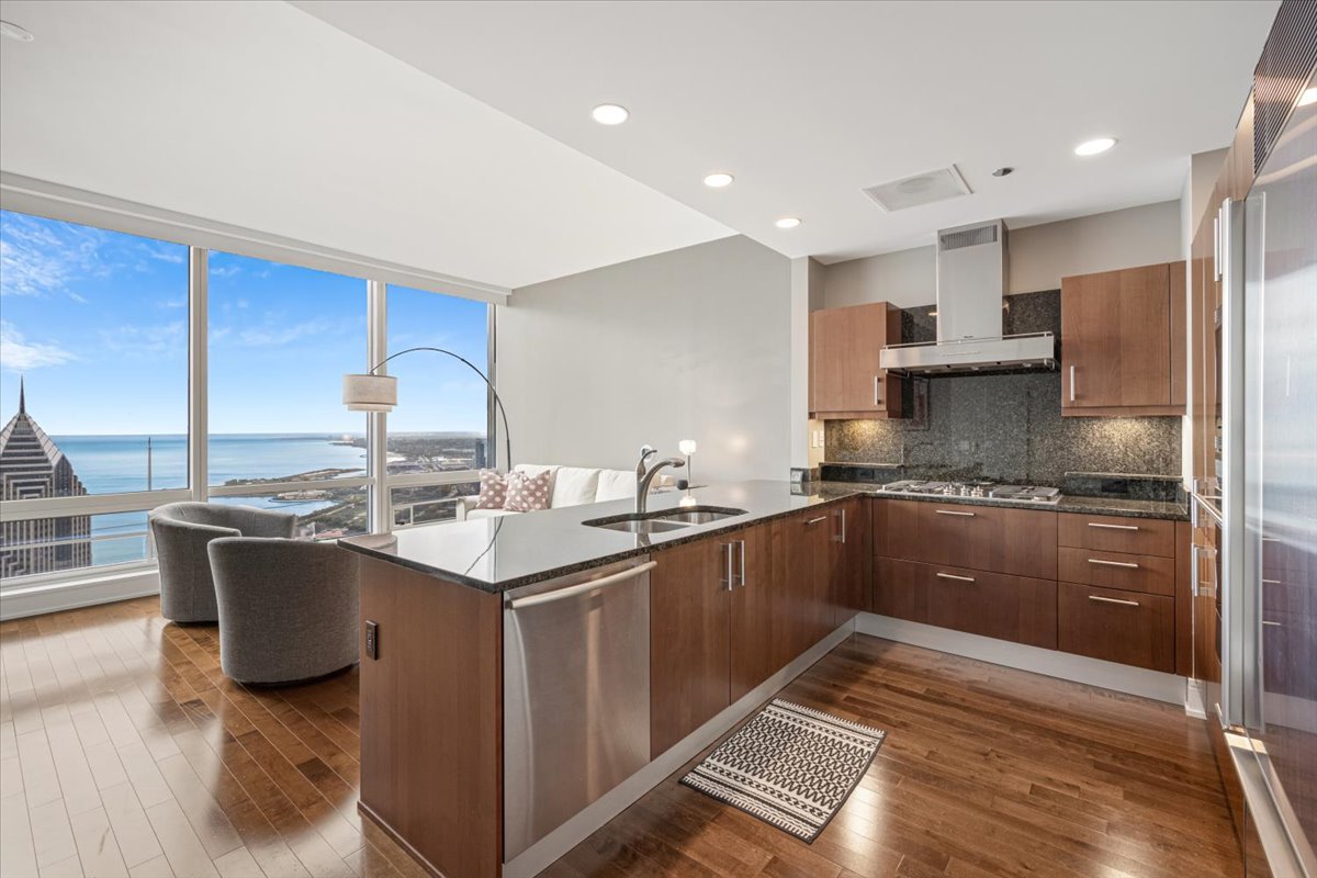 401 North Wabash Avenue, Unit 69F Chicago, IL 60611 - Photo 5 of 35 a kitchen with stainless steel appliances granite countertop a sink stove and refrigerator