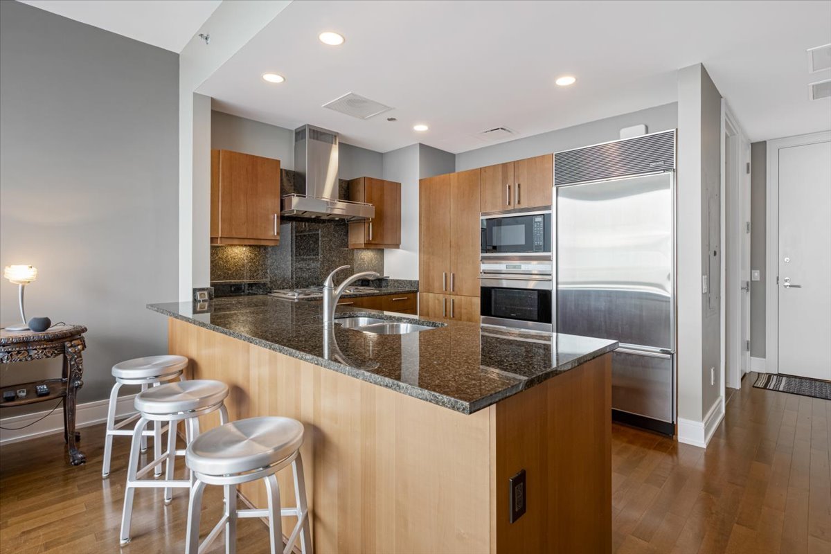 401 North Wabash Avenue, Unit 69F Chicago, IL 60611 - Photo 6 of 35 a kitchen with stainless steel appliances granite countertop a sink and a refrigerator