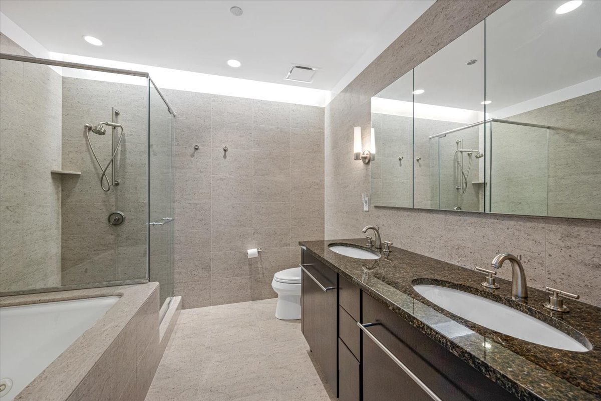 401 North Wabash Avenue, Unit 69F Chicago, IL 60611 - Photo 9 of 35 a bathroom with a granite countertop sink a toilet and shower