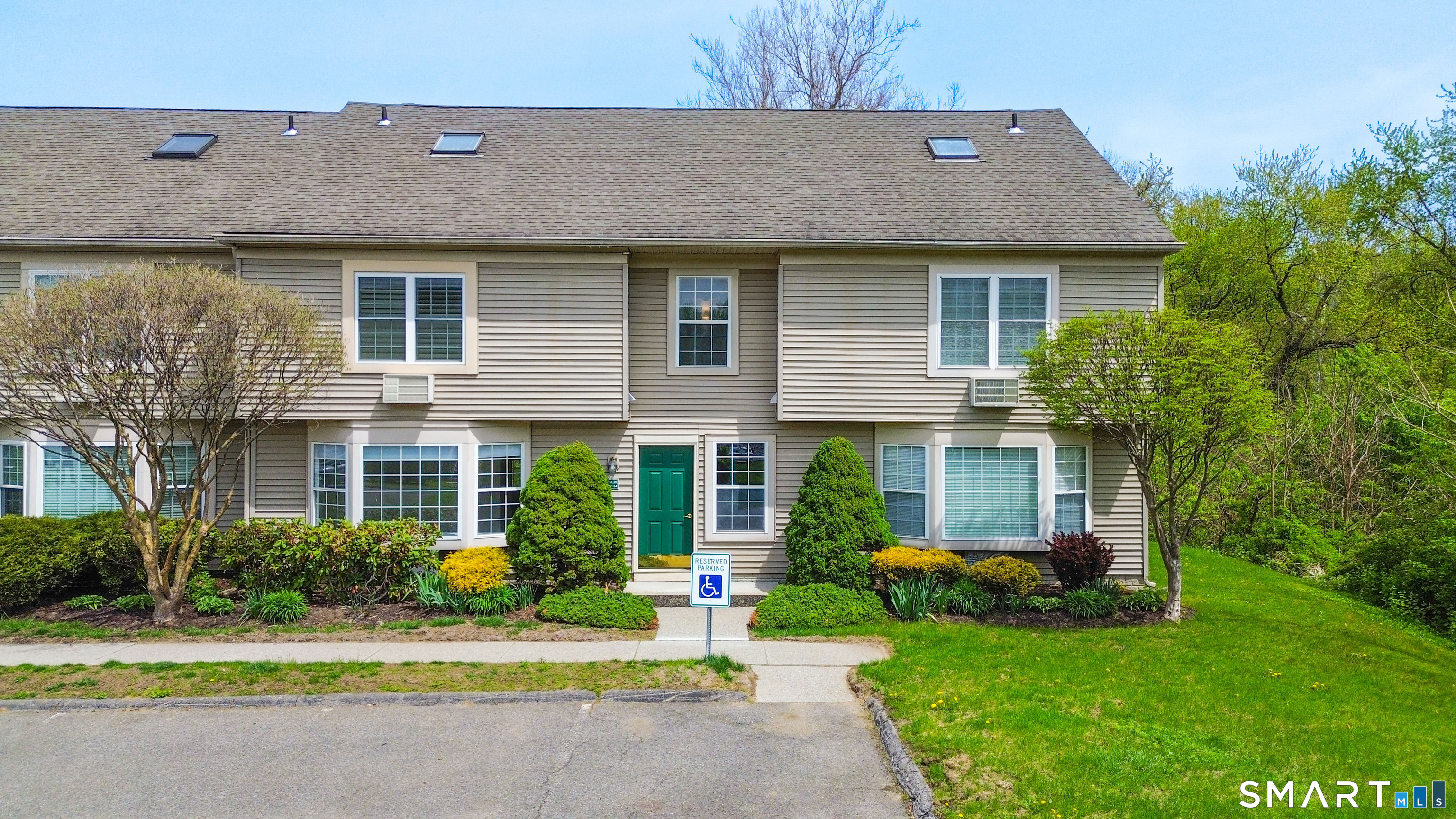 63 Glen Ridge Court, Unit 63 New Milford, CT 06776 - Photo 1 of 15 front view of a house with a yard