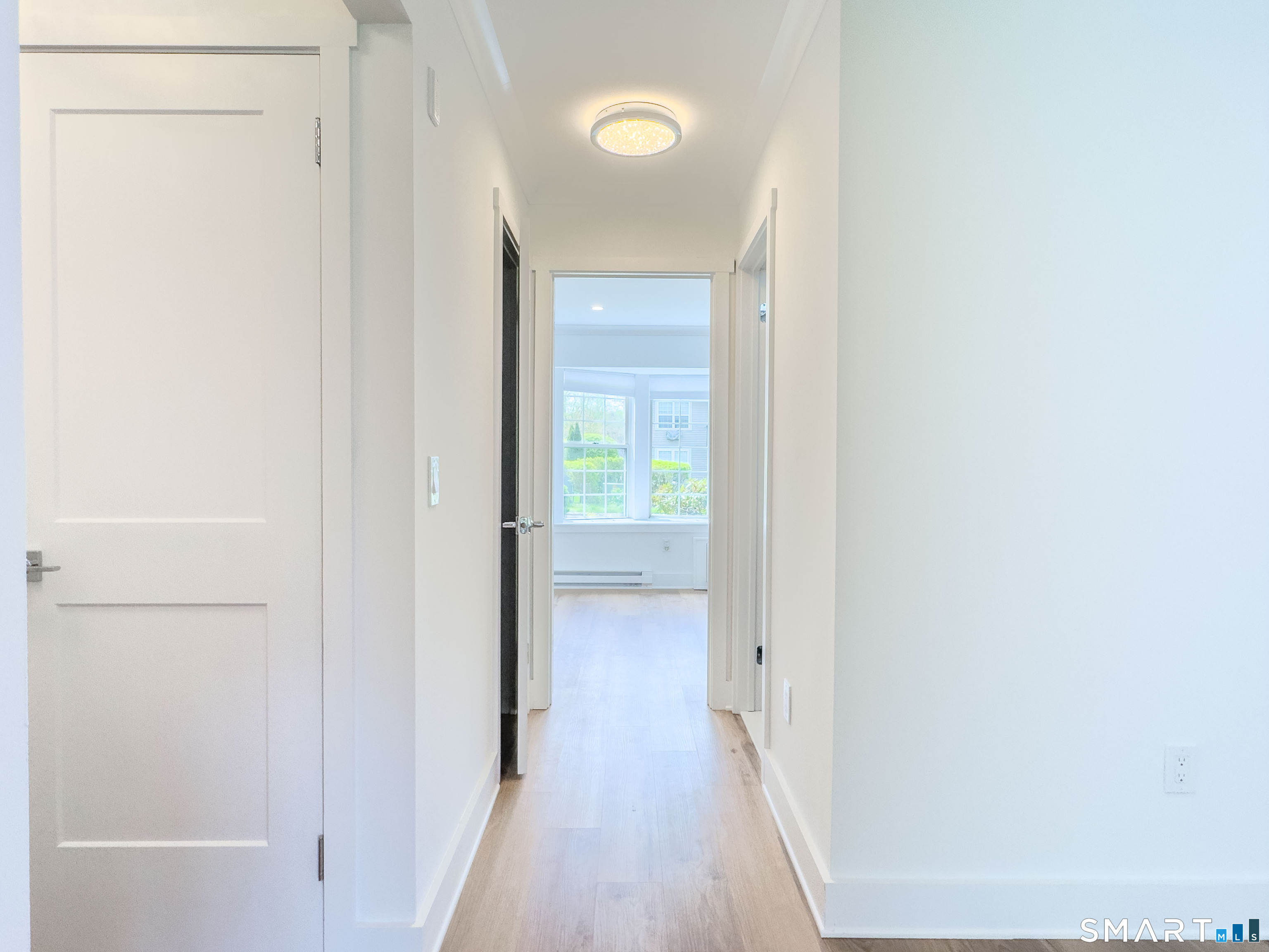 63 Glen Ridge Court, Unit 63 New Milford, CT 06776 - Photo 12 of 15 a view of a hallway with wooden floor