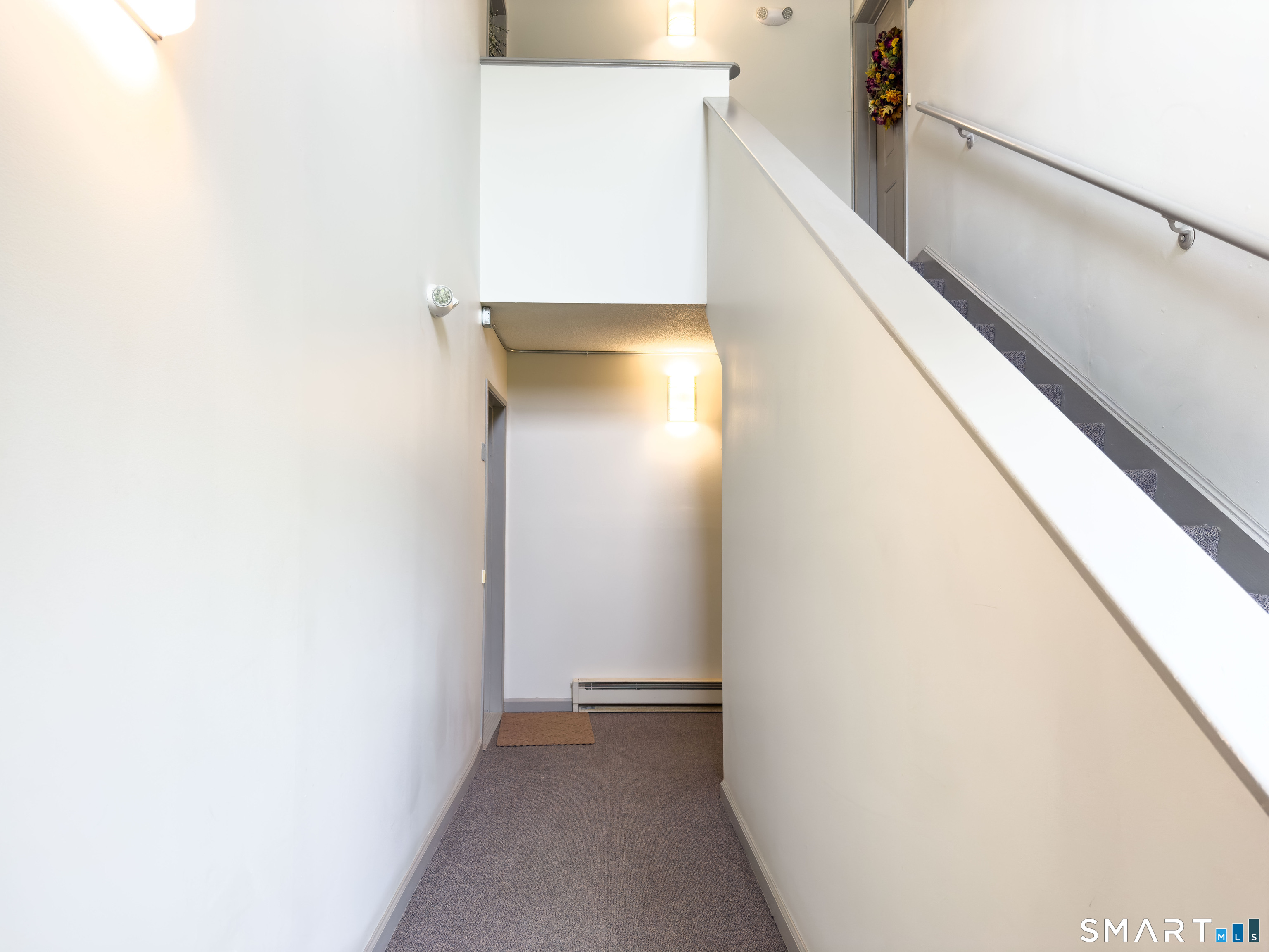 63 Glen Ridge Court, Unit 63 New Milford, CT 06776 - Photo 13 of 15 a view of hallway with stairs
