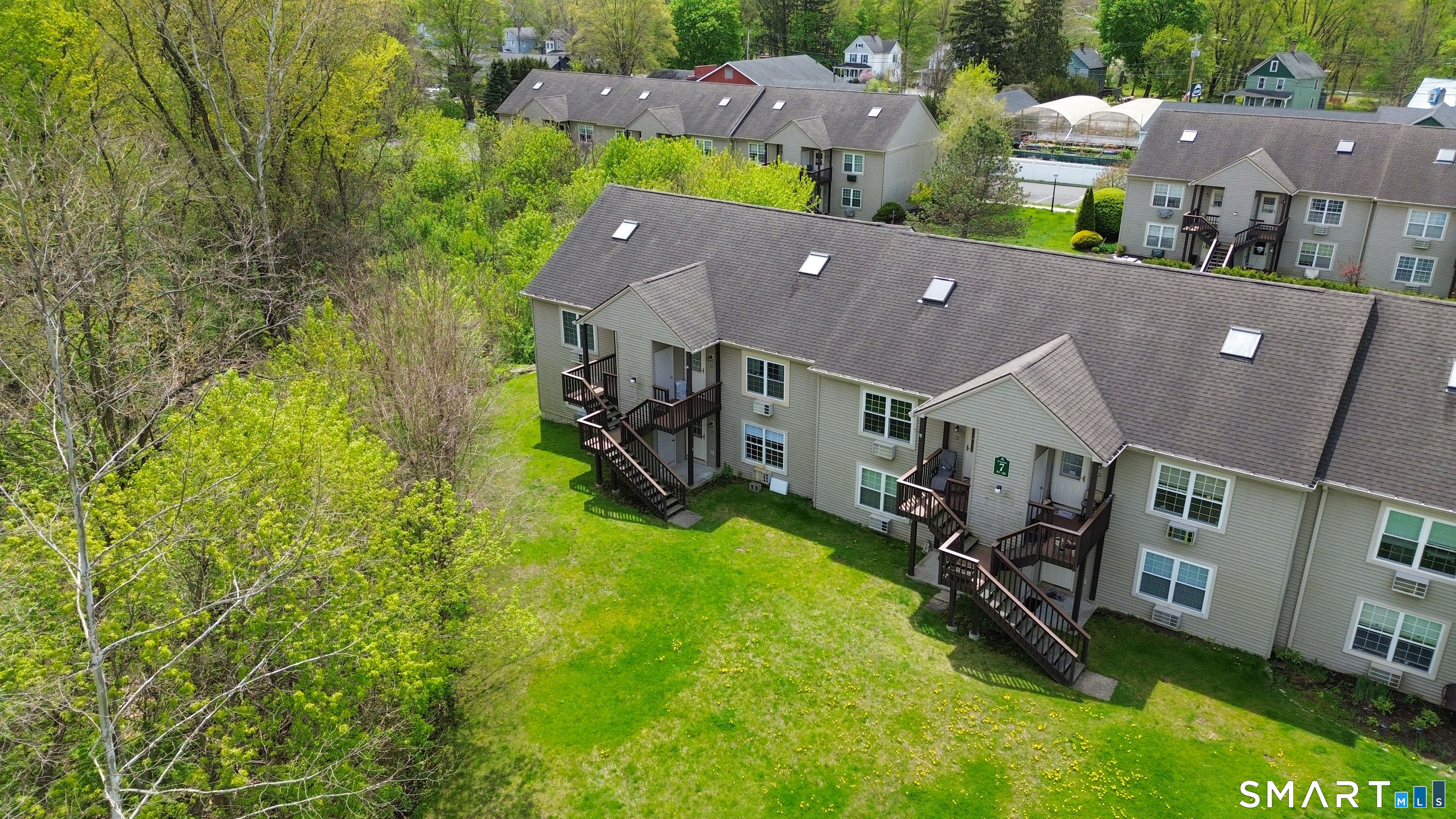 63 Glen Ridge Court, Unit 63 New Milford, CT 06776 - Photo 14 of 15 an aerial view of residential houses with outdoor space and trees all around