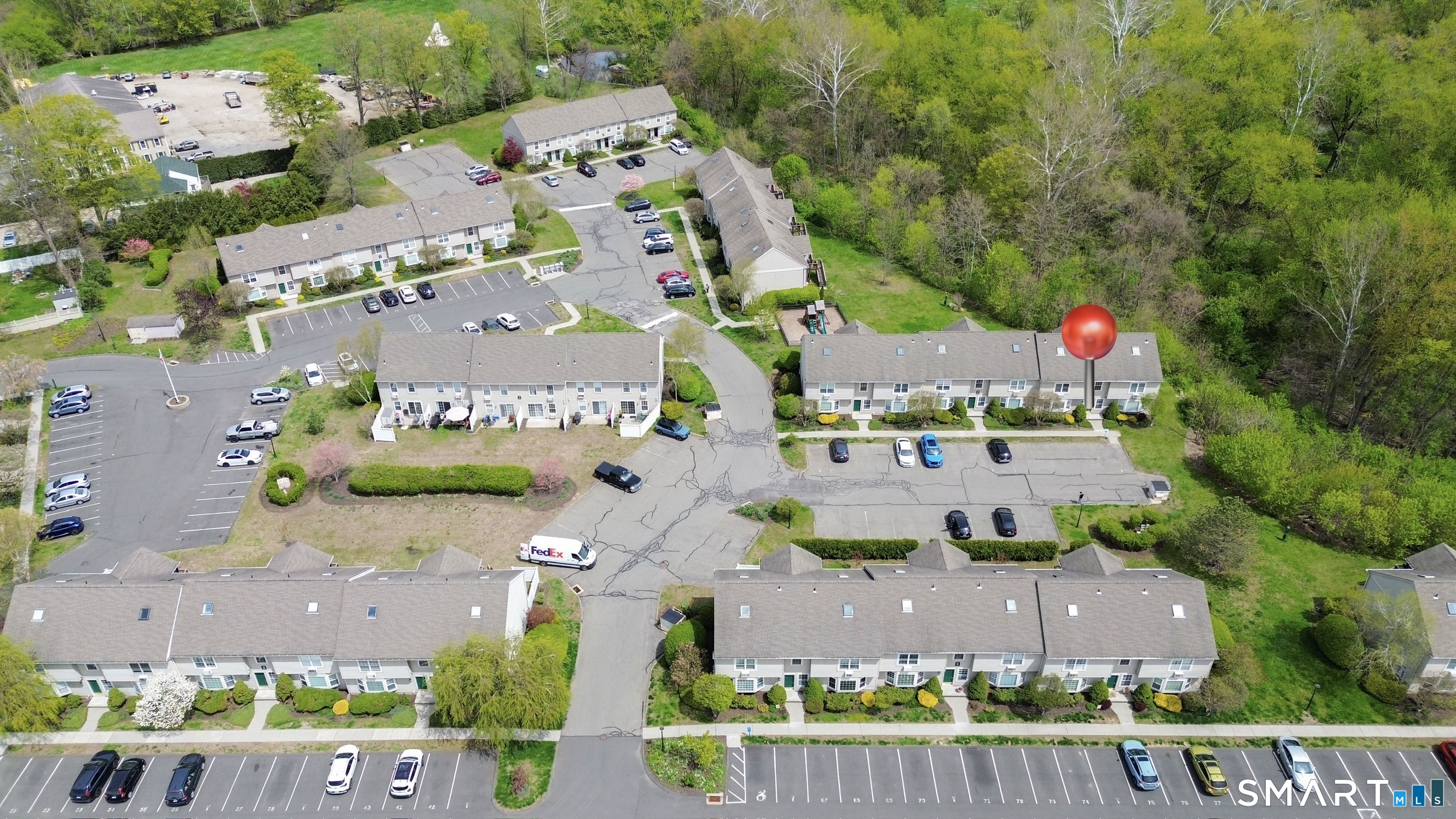63 Glen Ridge Court, Unit 63 New Milford, CT 06776 - Photo 2 of 15 an aerial view of multiple houses with yard