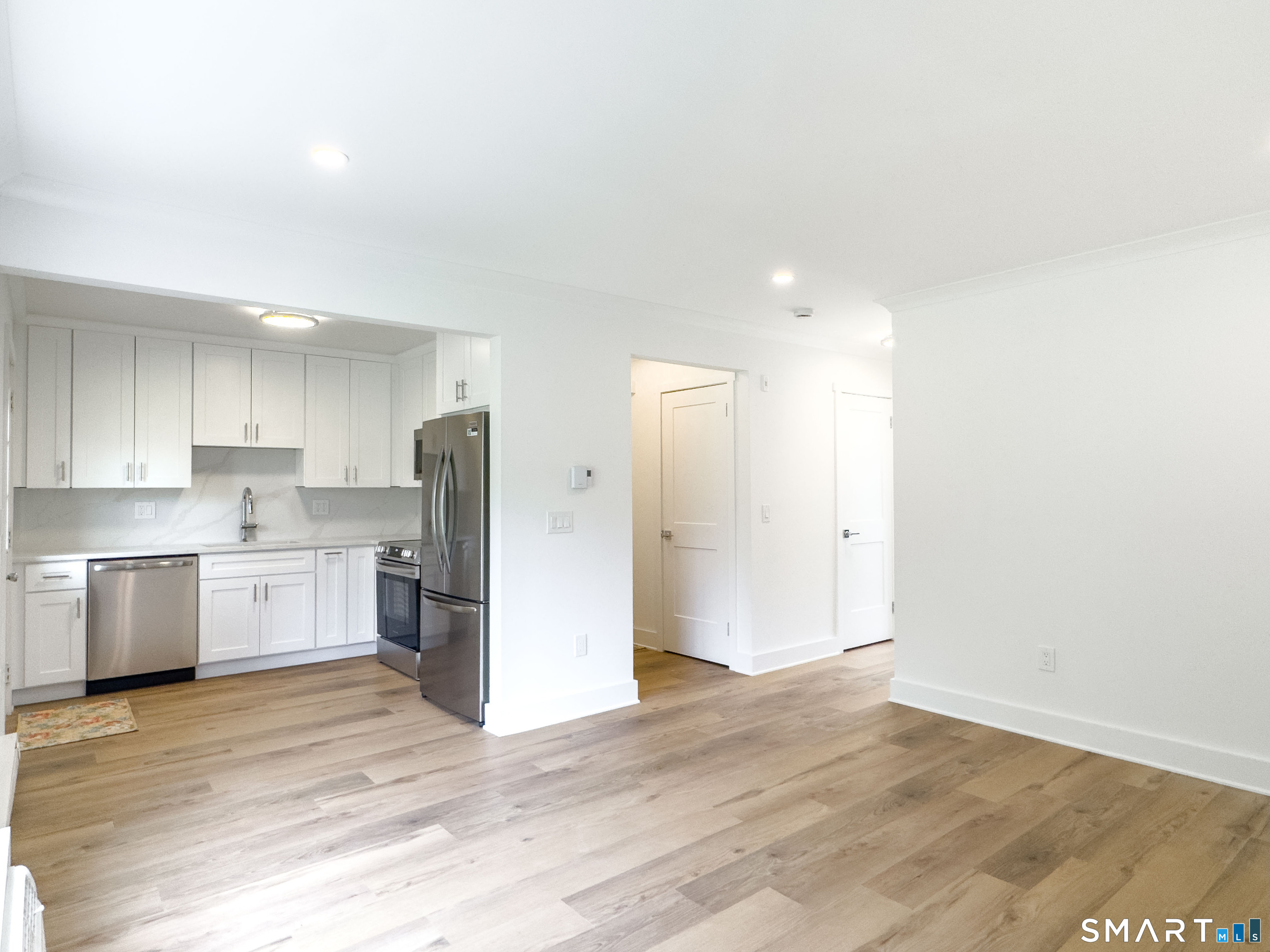 63 Glen Ridge Court, Unit 63 New Milford, CT 06776 - Photo 5 of 15 a kitchen with a refrigerator and a stove top oven
