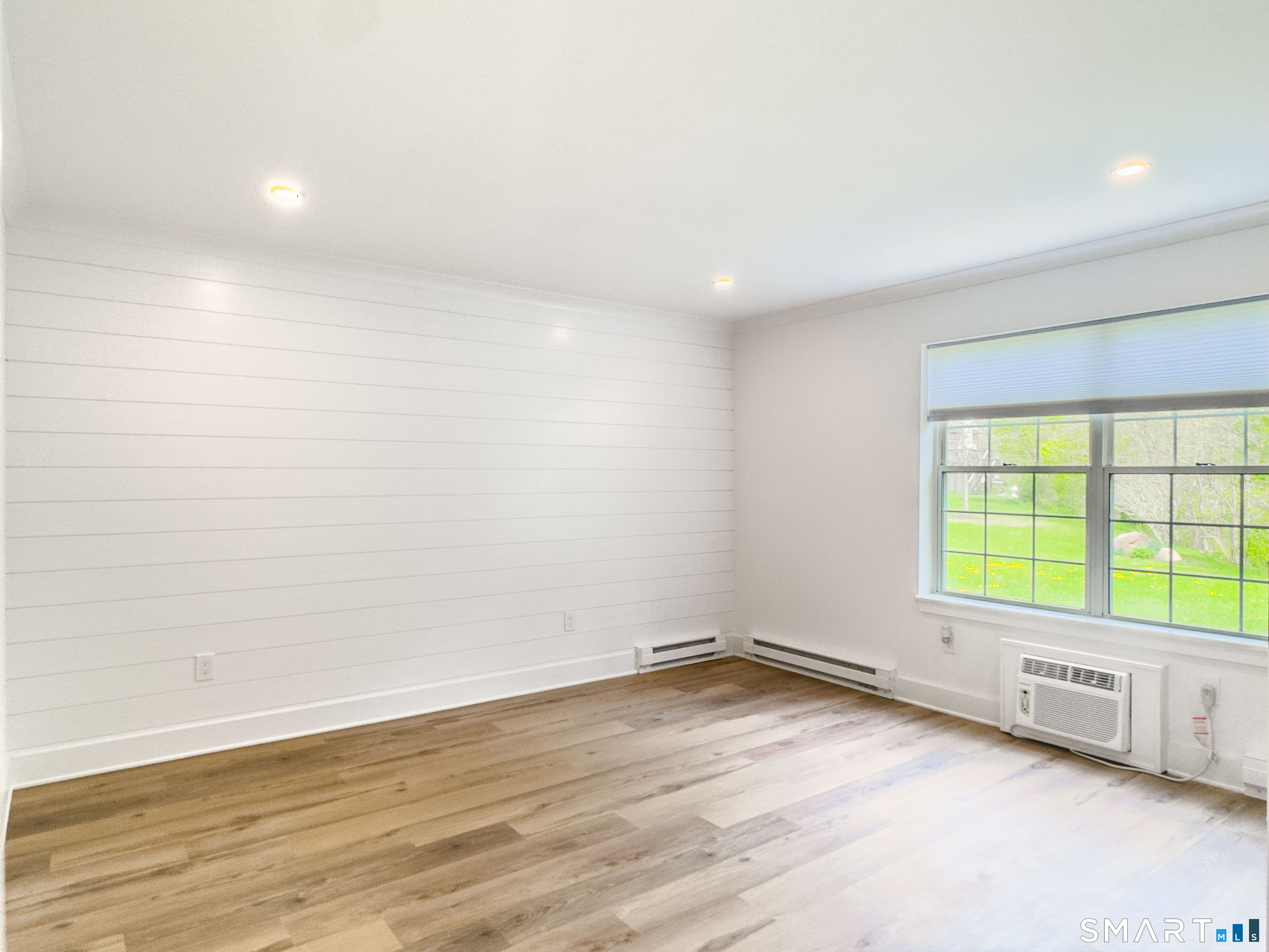 63 Glen Ridge Court, Unit 63 New Milford, CT 06776 - Photo 6 of 15 a view of an empty room with a window