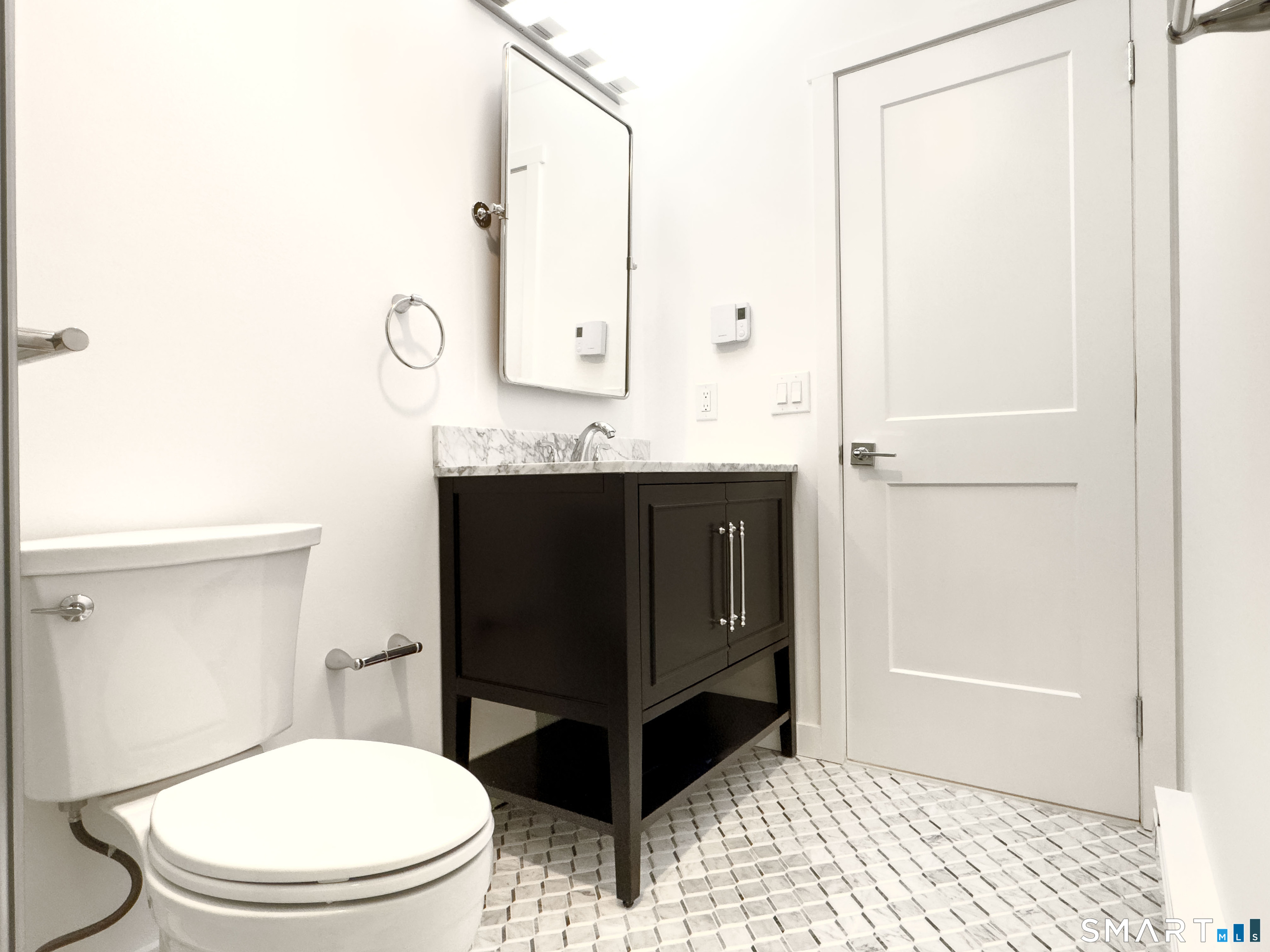 63 Glen Ridge Court, Unit 63 New Milford, CT 06776 - Photo 8 of 15 a bathroom with a sink a toilet and shower