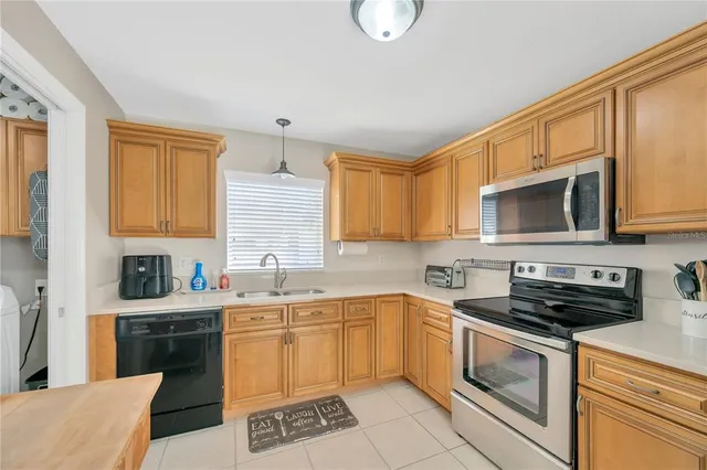 a kitchen with stainless steel appliances a stove a sink a stove and cabinets