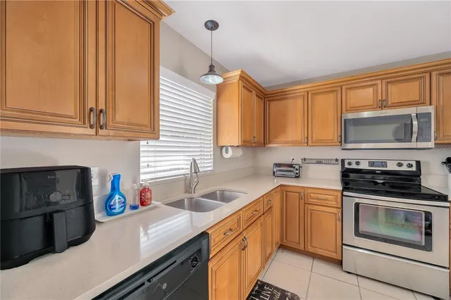 a kitchen with stainless steel appliances a stove sink microwave and cabinets