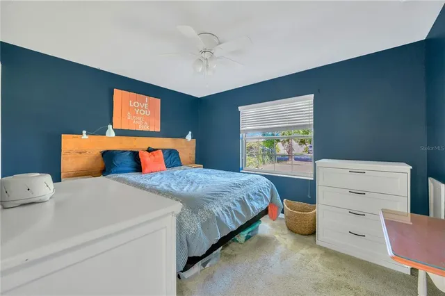 a bathroom with a granite countertop toilet a sink and a large mirror