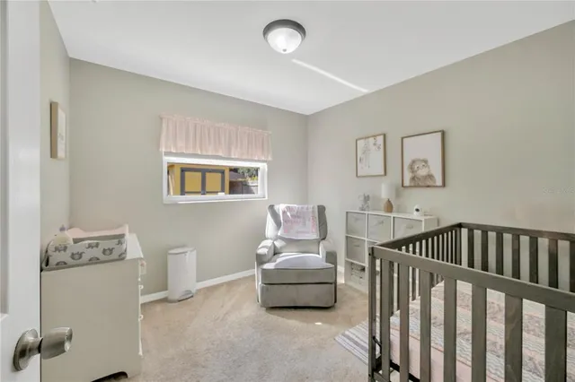 a room with a baby crib and a window