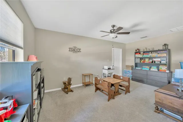 a living room with furniture and a book shelf