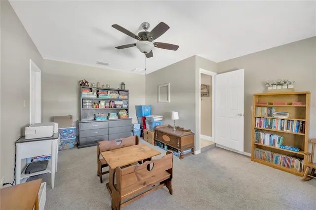 a living room with furniture a fireplace and a chandelier