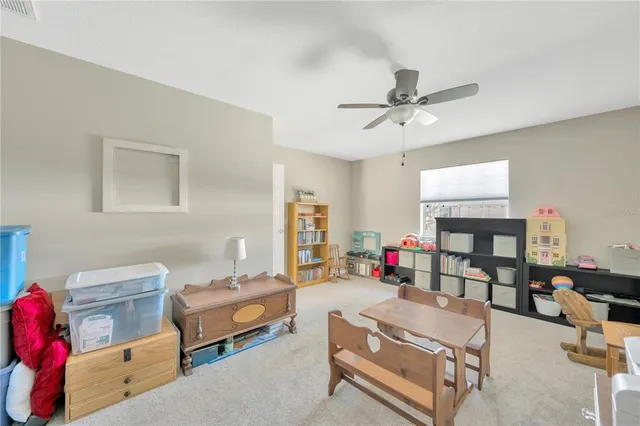 a view of backyard with swimming pool and outdoor seating
