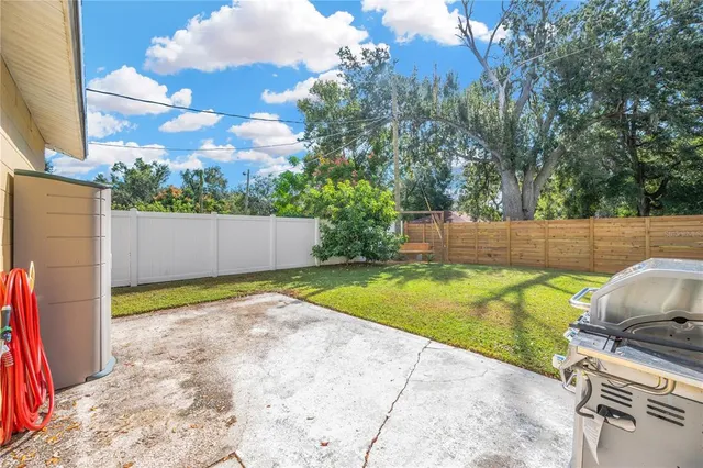 a view of a backyard with swimming pool